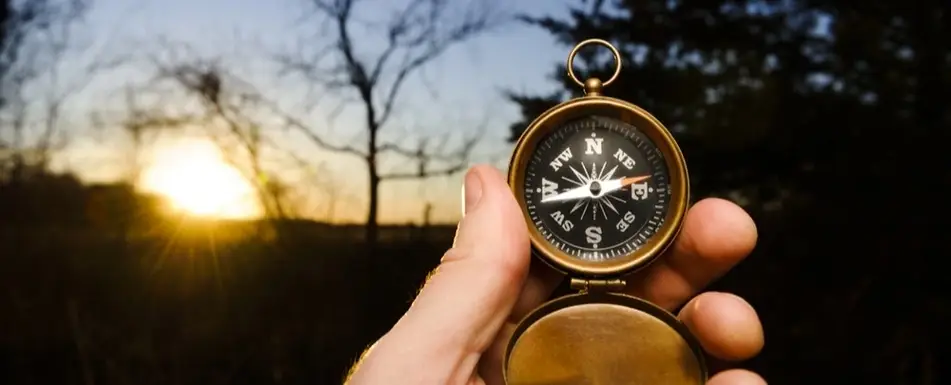 A person holding a compass.