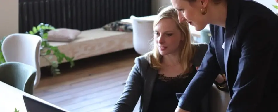 Two people looking at a computer.