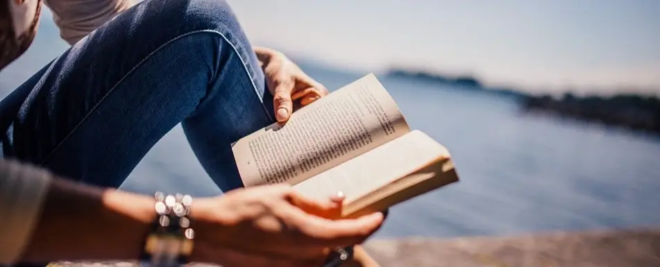 Someone reading by the water.