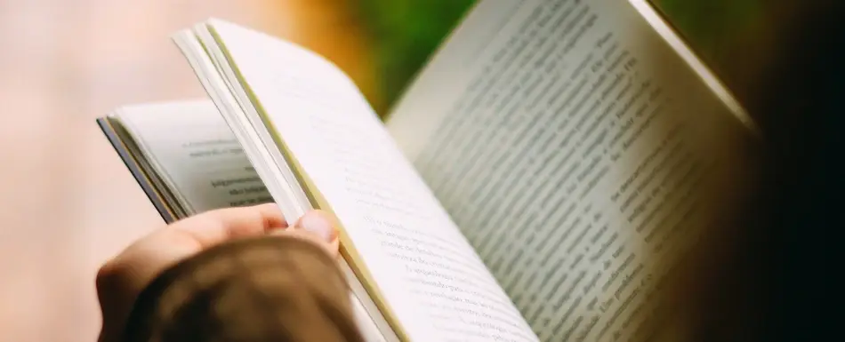 person leafing through book