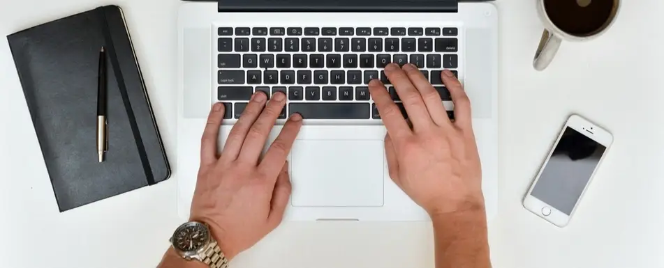 Overhead shot of someone typing at a computer.