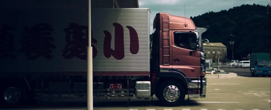 A truck pulling out of an underpass.