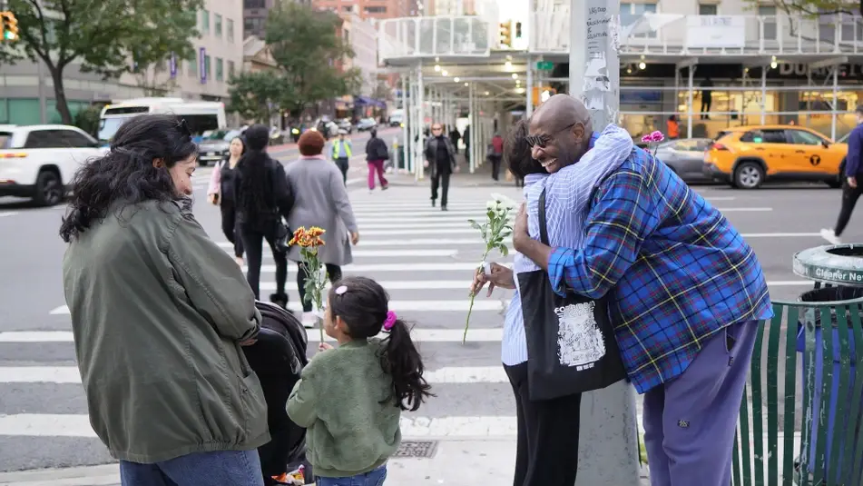 two people hugging after exchanging flowers