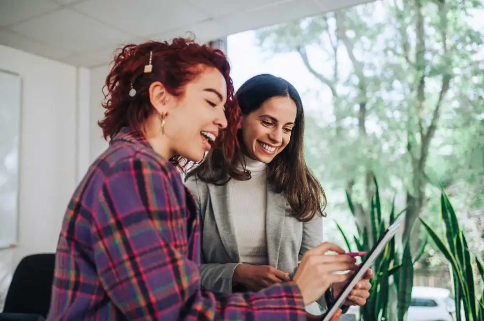 Dos mujeres discutiendo positivamente sobre un resultado.