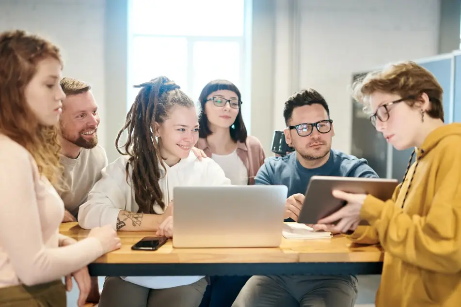 Grupo de personas reunidas mirando una tableta