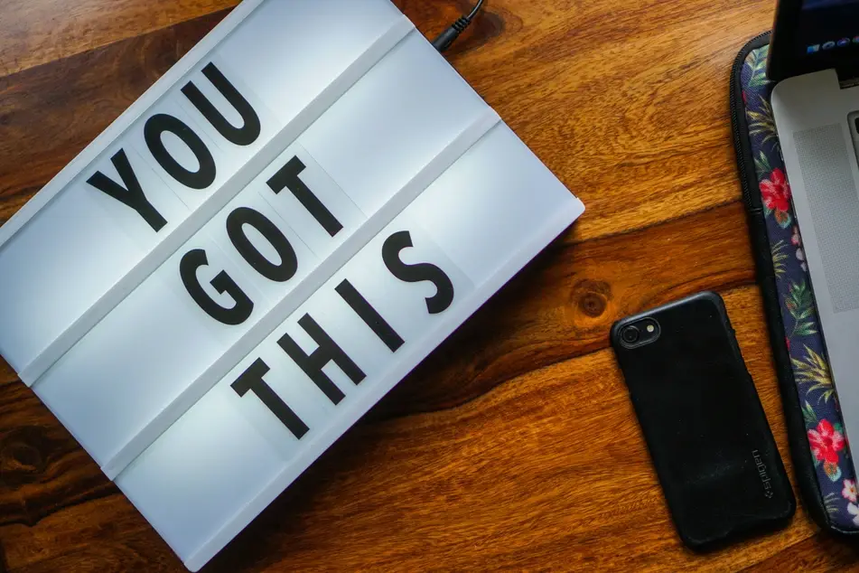 "you got this" written on a board next to a computer