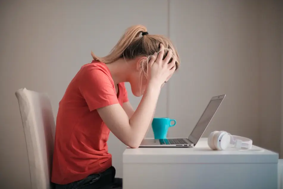 woman looking stressed at desk