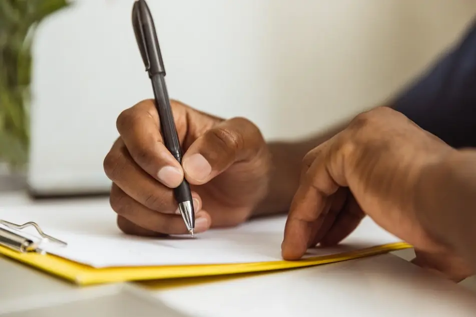 Close-up of hand writing a letter