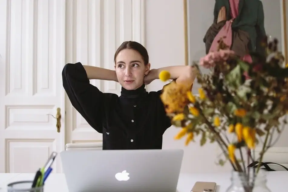 woman at desk with yellow flowers