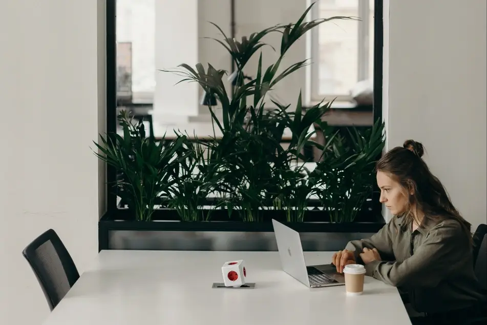 woman in empty office on laptop